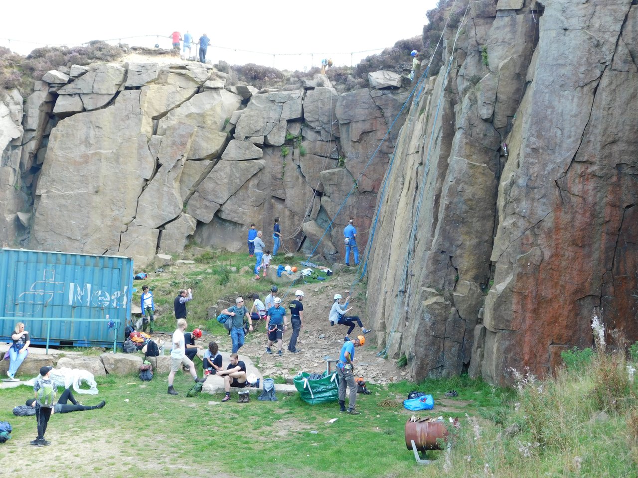 Many climbers rock climbing outdoors